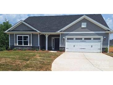 Charming single Gathering home with a two-car garage and stone accents along the base at 230 Mountain Island Dr # 39, Statesville, NC 28677
