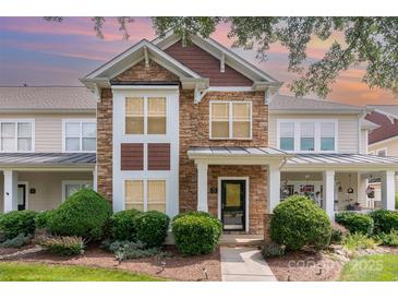 Charming townhome with stone accents, manicured landscaping, and welcoming front entrance at 2324 Bonterra Blvd, Indian Trail, NC 28079