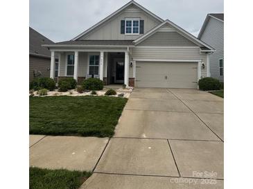 Charming single-Gathering home with a well-maintained lawn, inviting curb appeal, and an attached two car garage at 274 Robinwood Ln, Lake Wylie, SC 29710