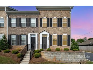 Brick townhome featuring well-maintained landscaping and a front yard at 309 N Aspen St, Lincolnton, NC 28092
