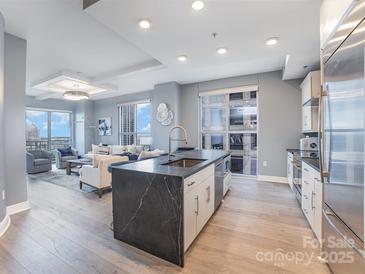 Open concept kitchen with island, stainless appliances, and views at 333 W Trade St # 1500, Charlotte, NC 28202