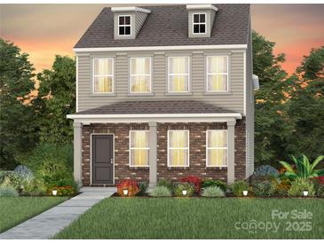 Charming two-story home with a brick facade and manicured landscaping at 3636 Edisto Pl # 120, Monroe, NC 28110