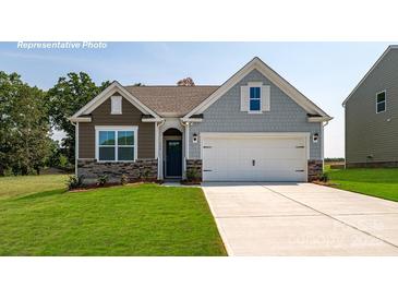Charming single-Gathering home featuring a manicured lawn and a two-car garage on a sunny day at 3940 Ashton Nw Dr, Conover, NC 28613