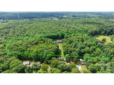 An aerial view showcases vast acreage and the home's position surrounded by a border of green foliage at 4916 Leepers Creek Rd, Maiden, NC 28650