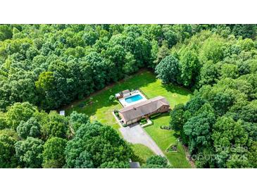Expansive aerial view of estate home surrounded by lush greenery, pool, and a long driveway at 4916 Leepers Creek Rd, Maiden, NC 28650
