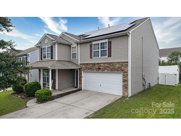Charming two-story home with a stone-accented garage and manicured lawn at 8511 Redding Glen Ave, Charlotte, NC 28216