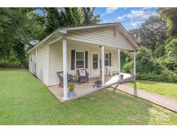 Charming home featuring a cozy front porch with seating and decorative plants at 1016 W 10Th Ave, Gastonia, NC 28052