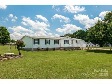 Charming single-story home with white siding, black shutters, and a well-manicured lawn at 1107 Richard Rd, Salisbury, NC 28147
