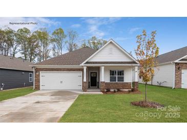 Charming single-story home featuring a two-car garage and landscaped front yard with a stone and white facade at 130 Parker Claire Ln, Kings Mountain, NC 28086