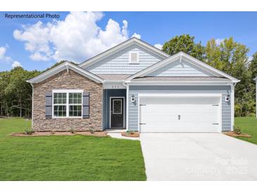Charming one-story home featuring stone accents, a two-car garage, and a well-maintained front lawn at 150 Parker Claire Ln, Kings Mountain, NC 28086