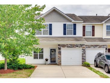 Charming townhome showcasing a stone facade, blue shutters and well-manicured landscaping at 2169 Shady Pond Dr, Clover, SC 29710
