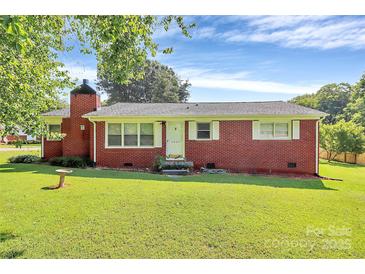 Charming red brick home features a well-manicured lawn and classic design details at 2601 Marldale St, Gastonia, NC 28052