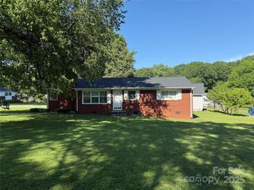 Charming brick home featuring a well-manicured lawn and mature trees, offering a welcoming curb appeal at 2601 Marldale St, Gastonia, NC 28052