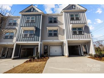 A row of modern townhomes featuring eye-catching facades and attached garages, creating an inviting neighborhood street view at 3128 Butler Hill Dr, Matthews, NC 28105