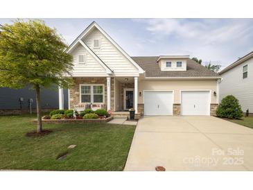 Charming two-story home boasts a well-manicured lawn, stone accents, and a convenient two-car garage at 363 Bellingrath Blvd, Rock Hill, SC 29730