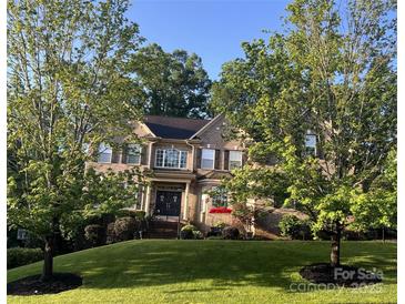 Charming two-story brick home with mature trees and a well-manicured lawn in a desirable neighborhood at 9913 Hazelview Dr, Charlotte, NC 28277