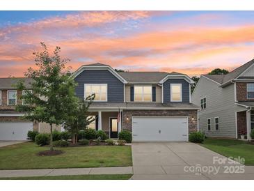 Charming two-story home with stone accents, neutral siding, a well-manicured lawn, and a two-car garage at 107 Sequoia St, Mooresville, NC 28117