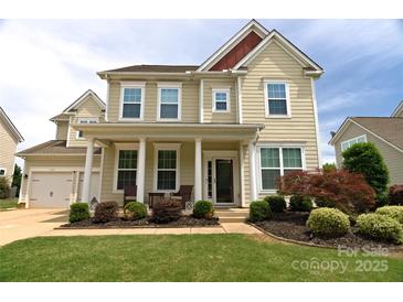 Charming two-story home with inviting front porch, manicured lawn, and attached garage in desirable neighborhood at 137 Flora Vista Dr, Mooresville, NC 28117