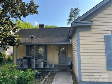 Charming home featuring a cozy front porch with vintage-style railings, providing a welcoming entrance at 142 Wylie St, Chester, SC 29706