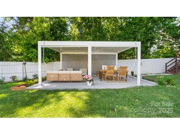 Cozy outdoor patio area with stylish seating, dining area, and ambient string lights for evening relaxation at 1446 Downs Ave, Charlotte, NC 28205