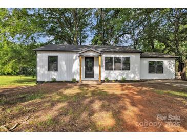 Charming white home with black trim, a cozy front porch and a large lot with mature shade trees at 1739 16Th Ne St, Hickory, NC 28601