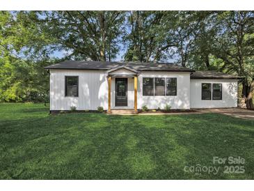 Charming home with a well-manicured lawn and a freshly painted exterior and black trim at 1739 16Th Ne St, Hickory, NC 28601