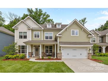 Charming two-story home featuring a covered front porch and attached two-car garage at 20307 Creek Bend Edge Ct # 10, Matthews, NC 28105