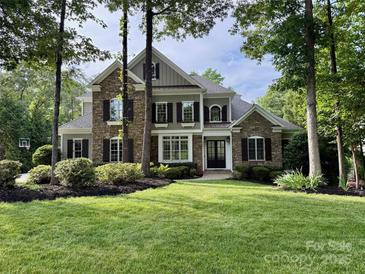Beautiful stone and wood facade home with manicured lawn and mature trees at 238 Horton Grove Rd, Fort Mill, SC 29715