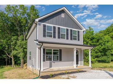 Two-story home with gray siding, black shutters, and a covered front porch at 304 Adams St, Salisbury, NC 28144