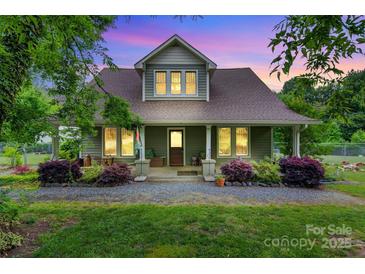 Charming home with lush landscaping, covered porch, and inviting curb appeal at 4335 E Nc 10 Hwy, Claremont, NC 28610