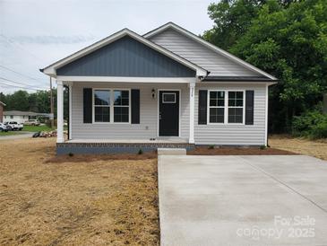 Charming single-story home with gray siding, black shutters, and a well-manicured front yard at 528 S Caldwell St, Salisbury, NC 28144