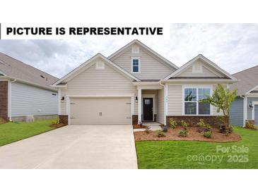 Charming single-story home features a well-manicured lawn, two-car garage, and inviting front porch at 106 Noah Ln, Troutman, NC 28166