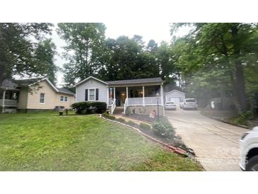 Charming single Gathering home with a beautiful front yard and a private driveway at 107 Oakland Rd, Belmont, NC 28012