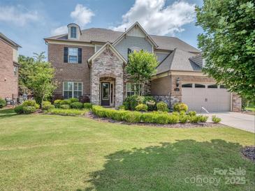 Charming two-story home with stone accents, manicured lawn, and attached two-car garage at 114 Reserve Ln, Fort Mill, SC 29707