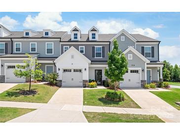 Charming townhomes feature attached garages, manicured lawns, and neutral color schemes at 13221 Gadwal Pintail Dr, Charlotte, NC 28262