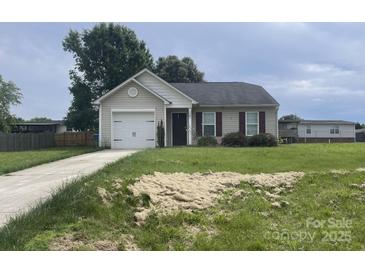 Charming single-story home with attached garage and well-maintained lawn with some hay spread out on the front yard at 1381 Steven Dr, Salisbury, NC 28147