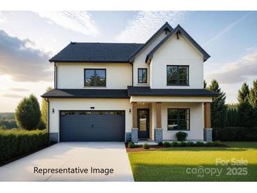 Two story home featuring a black roof, front-facing two car garage, and a well-manicured lawn at 20392 Queens St, Cornelius, NC 28031