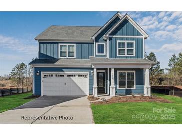Charming two-story home with blue siding, a white garage door, and well-maintained lawn at 20392 Queens St, Cornelius, NC 28031
