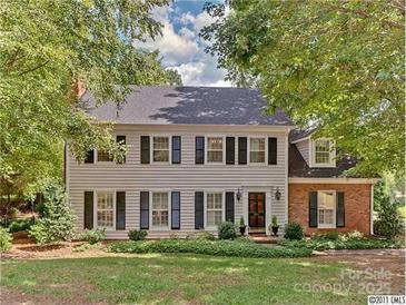 Charming two-story home featuring a well-maintained lawn and a combination of siding and brick exterior at 2311 Thornridge Rd, Charlotte, NC 28226