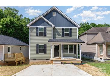 Charming two-story home with a cozy front porch and a neatly paved driveway at 312 Adams St, Salisbury, NC 28144