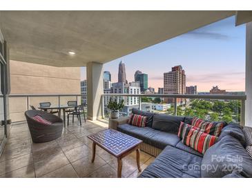 Relax on this condo balcony with a city view, complete with stylish seating and dining set at 520 E Martin Luther King Jr Blvd # 1002, Charlotte, NC 28202