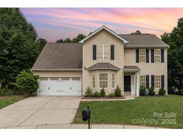 Charming two-story home featuring neutral siding, black shutters, and a well-manicured lawn at 6608 Pattonsburg Dr, Charlotte, NC 28213