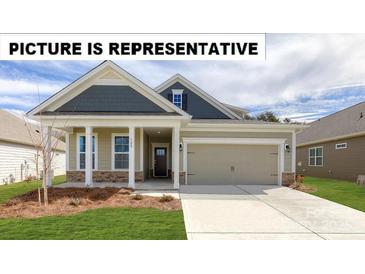 Charming single-Gathering home with a manicured lawn, a welcoming porch, and an attached two-car garage at 104 Noah Ln, Troutman, NC 28166