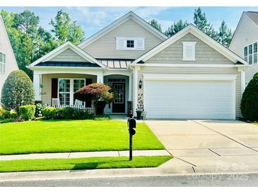 Charming single-Gathering home showcasing a well-manicured lawn and a two-car garage at 10405 Scotland Ave, Indian Land, SC 29707