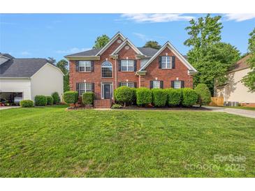 Charming brick two-story home featuring lush green lawn and manicured shrubbery enhancing curb appeal at 139 Forest Walk Way, Mooresville, NC 28115