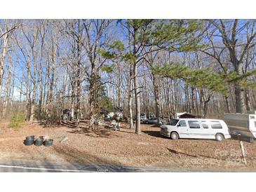 Picturesque property nestled amongst mature trees, a cozy single-story home, and multiple recreational vehicles at 2206 Meadow Rd, Clover, SC 29710