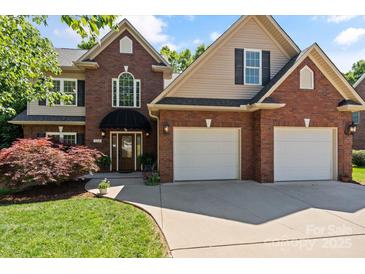 Traditional brick home featuring a well-manicured lawn and a convenient two-car garage at 3124 17Th Street Ne Ln, Hickory, NC 28601