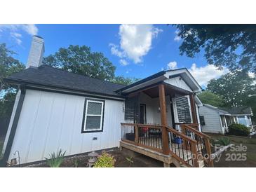 Cozy home featuring a quaint covered porch and a well-maintained, neutral exterior at 319 Leonard Ave, Albemarle, NC 28001