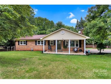 Charming one-story brick home featuring a covered front porch and a well-maintained lawn at 511 Apple Ln, Bessemer City, NC 28016