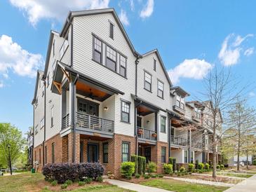 Charming townhome exteriors with brick accents and private balconies showcasing modern design and curb appeal at 933 E 36Th St, Charlotte, NC 28205